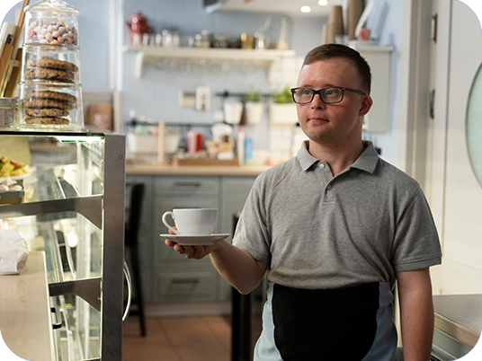 Man with down syndrome working in a coffee shop